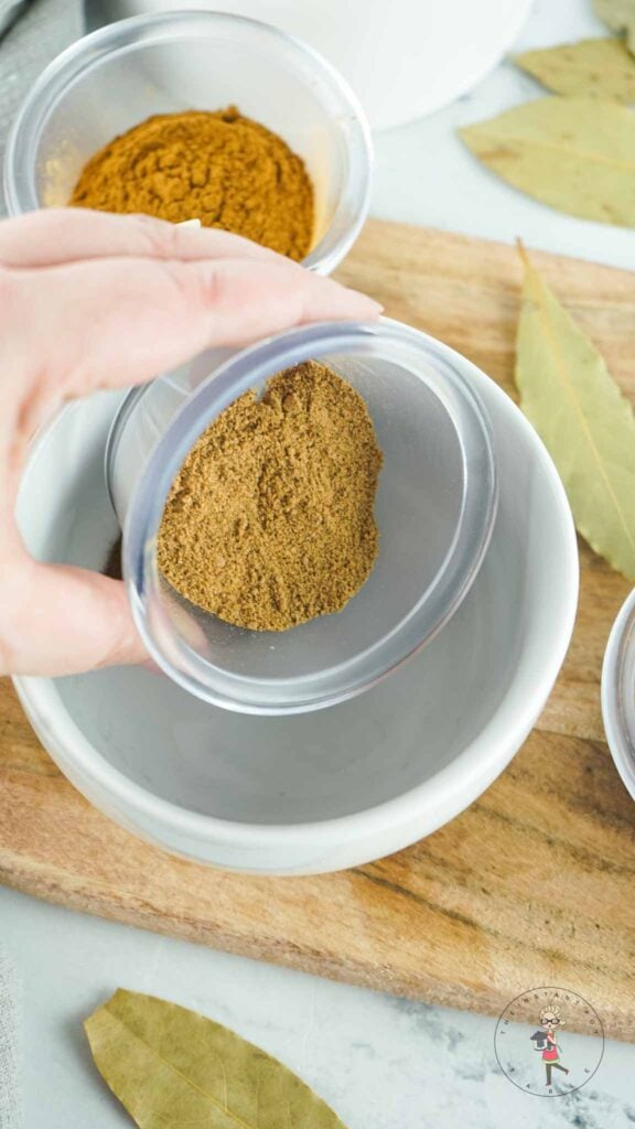 Adding spice to a bowl.