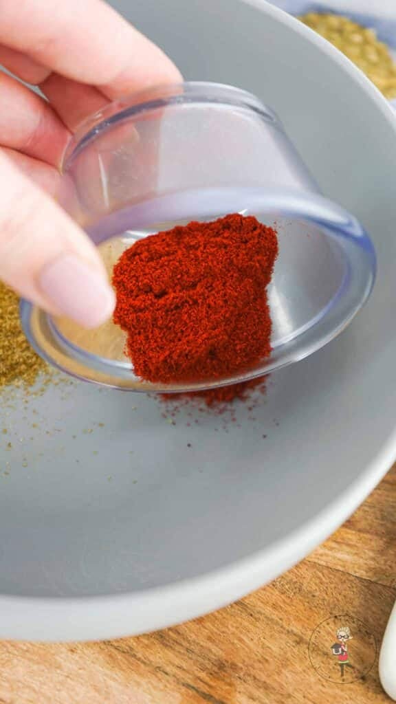 Adding spices to a bowl.