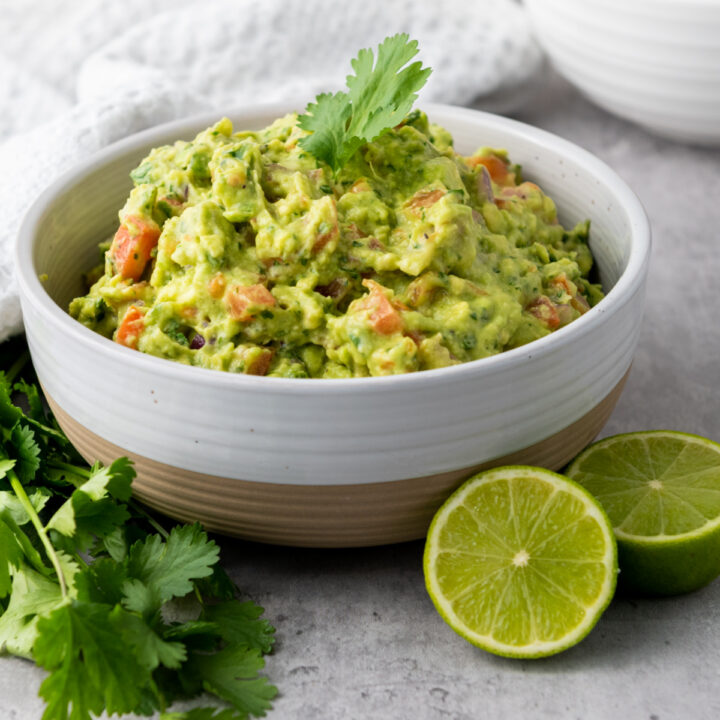 Easy Homemade Guacamole in a bowl with limes.